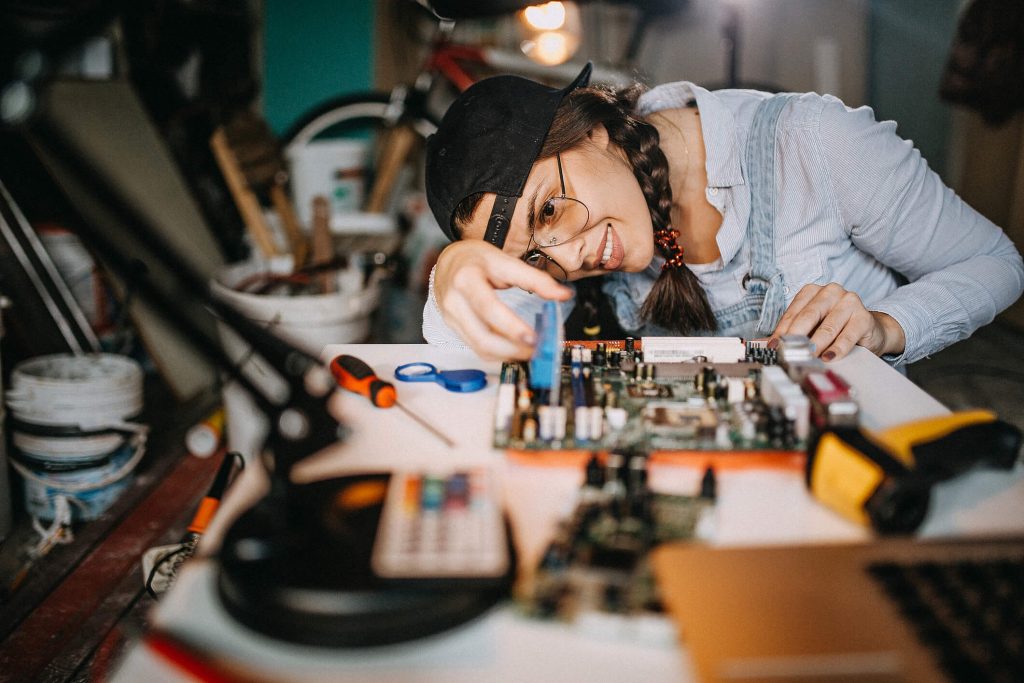 woman repairing electronic device